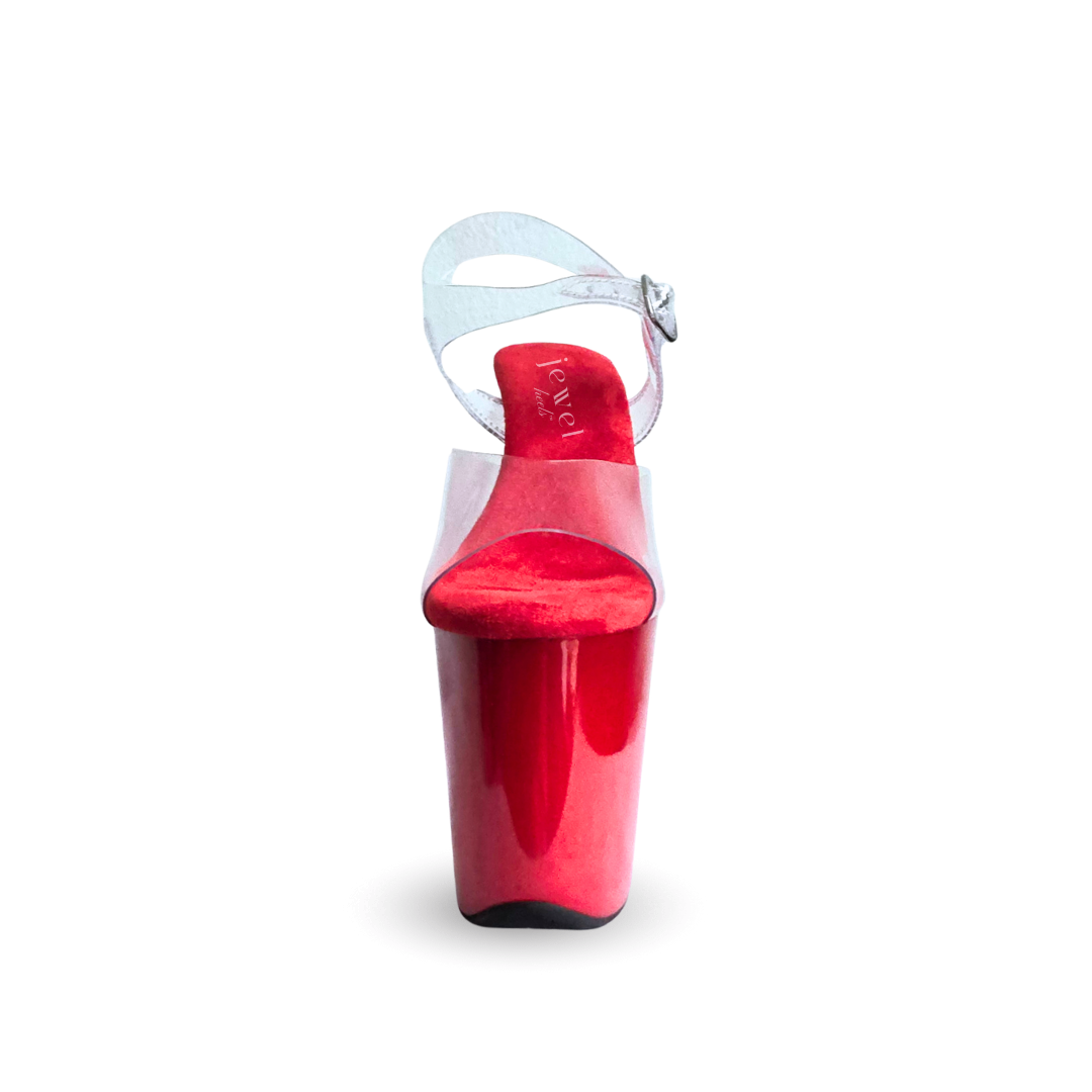Red high-heeled shoe with clear strap on a white background